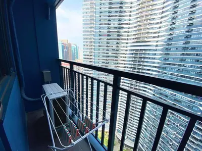 a balcony with a view of a large building at Air Residences with Fast Wifi in Manila