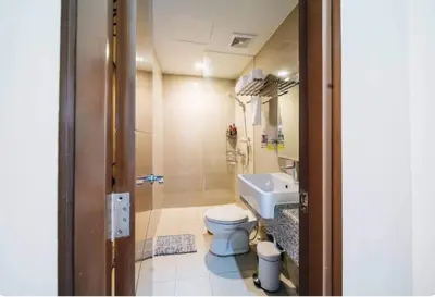 a bathroom with a toilet and a sink at The Florence Condo McKinley Hill in Manila