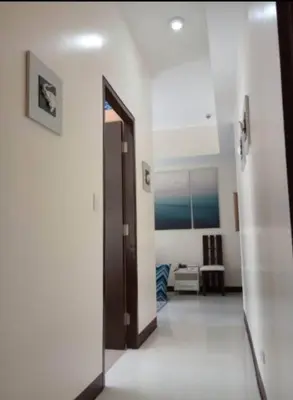 a hallway with a door and a room at The Florence Condo McKinley Hill in Manila