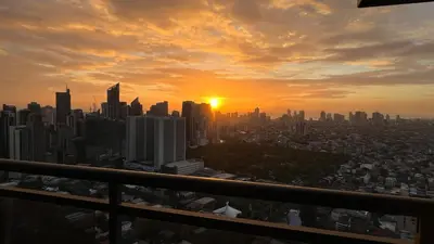 a view of a city skyline at sunset at The Milano Residences in Manila