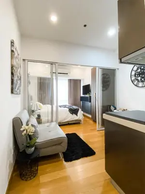 a living room with a couch and a bed at The Milano Residences in Manila