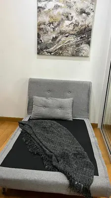 a bed in a room with a painting on the wall at The Milano Residences in Manila