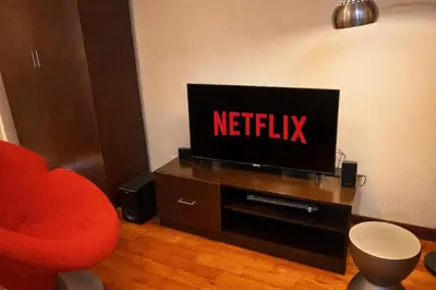 a living room with a television with the netflix sign on it at Mosaic 10H - Greenbelt Studio in Manila