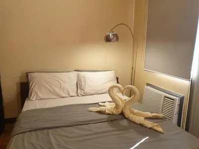 two snakes sitting on top of a bed at Mosaic 10H - Greenbelt Studio in Manila