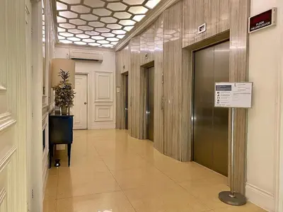 a hallway of a building with a door and a sign at Mosaic 10H - Greenbelt Studio in Manila