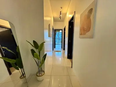 a hallway of a house with a potted plant at Grand Deluxe 3BR with Bathtub in Uptown BGC in Manila