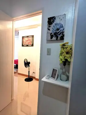 a room with a vase of flowers on a shelf at Budget Accomodation in San Pablo City Laguna in Manila