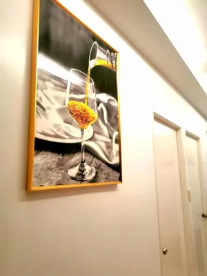 a picture of a glass of wine hanging on a wall at Budget Accomodation in San Pablo City Laguna in Manila