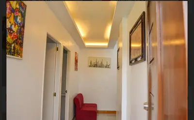 a hallway with a red chair and a ceiling at Budget Accomodation in San Pablo City Laguna in Manila