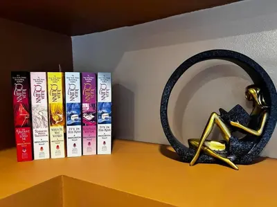 a mirror sitting on a shelf next to books at Staycation by JAR - Condo Unit in Manila