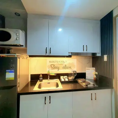 a kitchen with a sink and a sign that says stay alive at Kuro's Krib One Bedroom Condo Unit with Balcony at S Residences Pasay City MOA in Manila