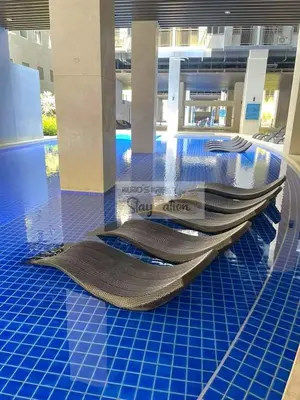 a swimming pool with escalators in a building at Kuro's Krib One Bedroom Condo Unit with Balcony at S Residences Pasay City MOA in Manila