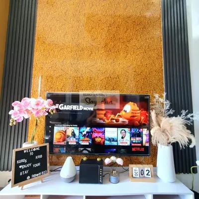 a room with a table with a tv on it at Kuro's Krib One Bedroom Condo Unit with Balcony at S Residences Pasay City MOA in Manila