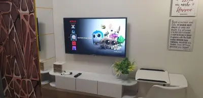 a flat screen tv hanging on a wall at Jejo Suite Home Shore 3 Residences Staycation 1 BR Unit Near MOA with Netflix and Prime Video in Manila