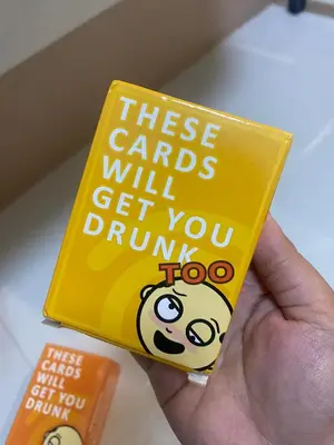 a person holding a book that says these cards will get you drink too at Jejo Suite Home Shore 3 Residences Staycation 1 BR Unit Near MOA with Netflix and Prime Video in Manila