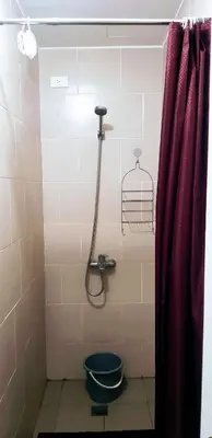 a bathroom with a shower with a toilet and a red curtain at Hantowah's Crib - Southwoods in San Pedro