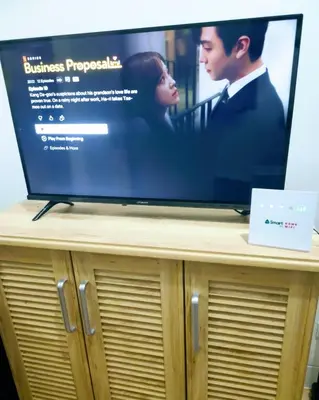 a flat screen tv sitting on top of a wooden cabinet at Hantowah's Crib - Southwoods in San Pedro