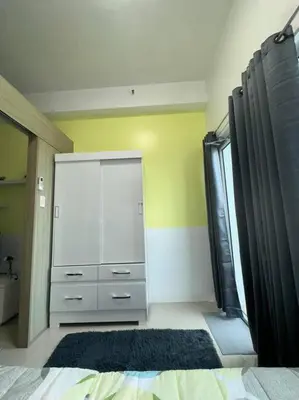 a bedroom with a bed and a dresser and a window at Night Blink Staycation and Rentals in Manila
