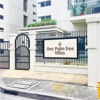 a one palm tree villas sign on a fence at One Palm and Two Palm Tree Villas in Manila