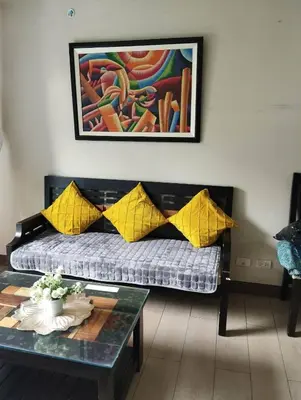 a living room with a couch and a table at Palm Tree Villas in Manila