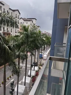 a view from the balcony of a building with palm trees at Palm Tree Villas in Manila
