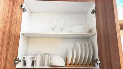 a cupboard with plates and wine glasses on it at Blissful Haven Suite Staycation Pasay Metro Manila near SM Mall of Asia Naia Airport Okada in Manila