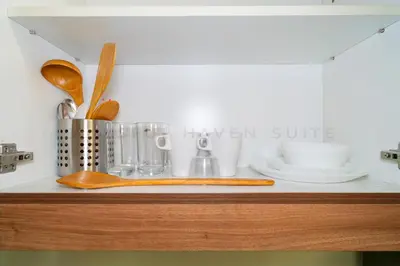 a shelf with utensils on top of a kitchen counter at Blissful Haven Suite Staycation Pasay Metro Manila near SM Mall of Asia Naia Airport Okada in Manila