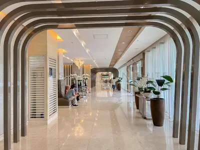 a lobby of a building with people sitting at Blissful Haven Suite Staycation Pasay Metro Manila near SM Mall of Asia Naia Airport Okada in Manila