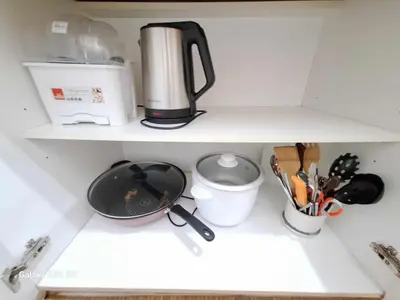 a kitchen counter with a coffee maker and kitchen utensils at Bright and Cozy 1 Bedroom with Balcony Pool View and WiFi in Grace Residences in Manila