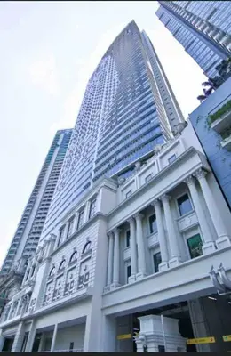 a large building with a tall skyscraper in the background at Uptown Parksuites BGC in Manila