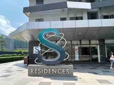 a large blue s sign in front of a building at ClaySky Staycation Cozy Modern 1BR unit near MOA with Netflix & HBO Max in Manila