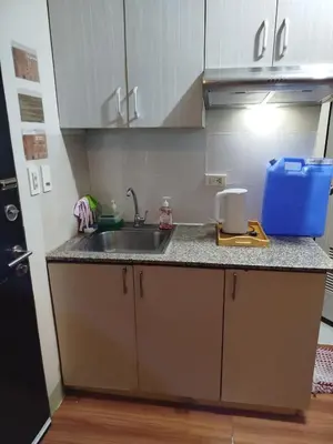 a kitchen with a sink and a counter top at 2-BR COZY condo 200mbpsFiberWiFi/Netflix/pool/WFH in Manila