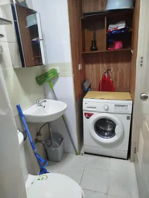 a bathroom with a washing machine and a sink at 2-BR COZY condo 200mbpsFiberWiFi/Netflix/pool/WFH in Manila