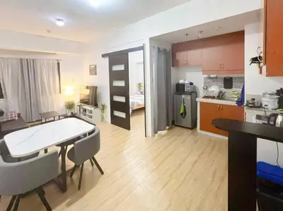 a kitchen and living room with a table and chairs at One Bedroom condo Unit in Eastwood Libis . Fast free wifi /netflix in Manila