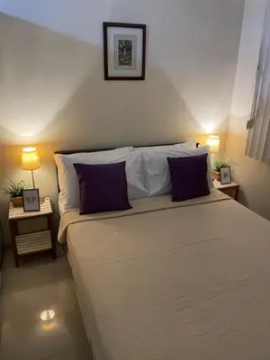 a bedroom with a large bed with two pillows at Justcondos at Sea Residences in Manila