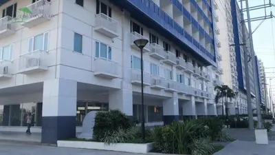 a building with a street light in front of it at Justcondos at Sea Residences in Manila