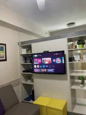 a room with a flat screen tv on a wall at Justcondos at Sea Residences in Manila