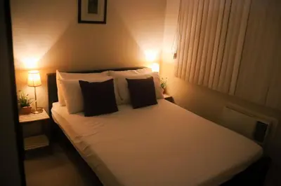 a bedroom with a white bed with two pillows at Justcondos at Sea Residences in Manila