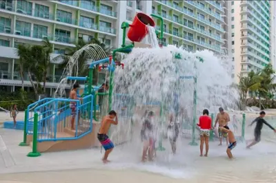 a group of people playing in a water park at Metro Manila Cityscape Charm at Azure Urban Resort Paranaque near NAIA Airport in Manila