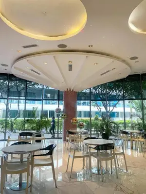 a dining room with tables and chairs in a building at Metro Manila Cityscape Charm at Azure Urban Resort Paranaque near NAIA Airport in Manila