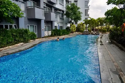 a swimming pool in front of a building at Casa De Camelina in Manila