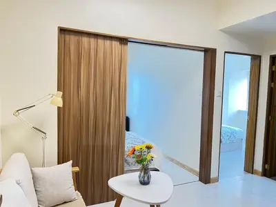 a living room with a vase of flowers on a table at Grand Riviera Suites in Manila