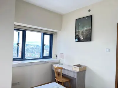 a room with a desk and a window at Grand Riviera Suites in Manila