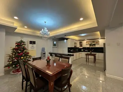 a kitchen with a table and a christmas tree in it at My Suite Heart of San Juan City near Greenhills, Ortigas with Roof Garden in Manila