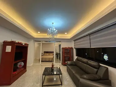 a living room with a couch and a television at My Suite Heart of San Juan City near Greenhills, Ortigas with Roof Garden in Manila
