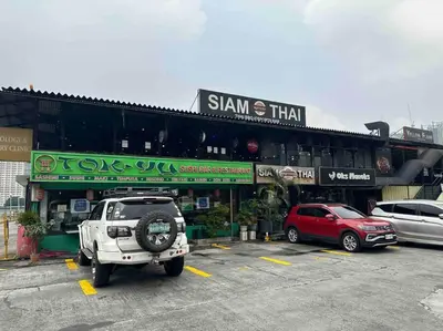 a car parked in a parking lot in front of a building at The DRYM Space — Curated Staycation in Mandaluyong in Manila