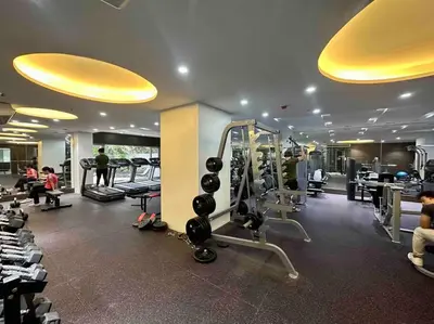 a gym with tread machines and people in a room at The DRYM Space — Curated Staycation in Mandaluyong in Manila
