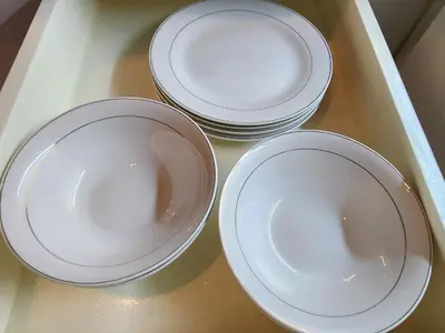 four white plates are sitting on a tray at 12e Spacious Cozy Suite at The Venice Mall with FREE Parking and Washing Machine in Manila