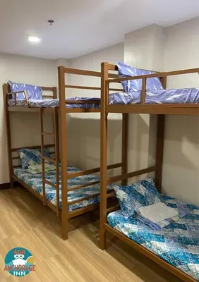 a room with three bunk beds in a dorm at AGB Anchorage Inn, male dorm in Manila