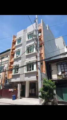 a tall building on the side of a street at AGB Anchorage Inn, male dorm in Manila